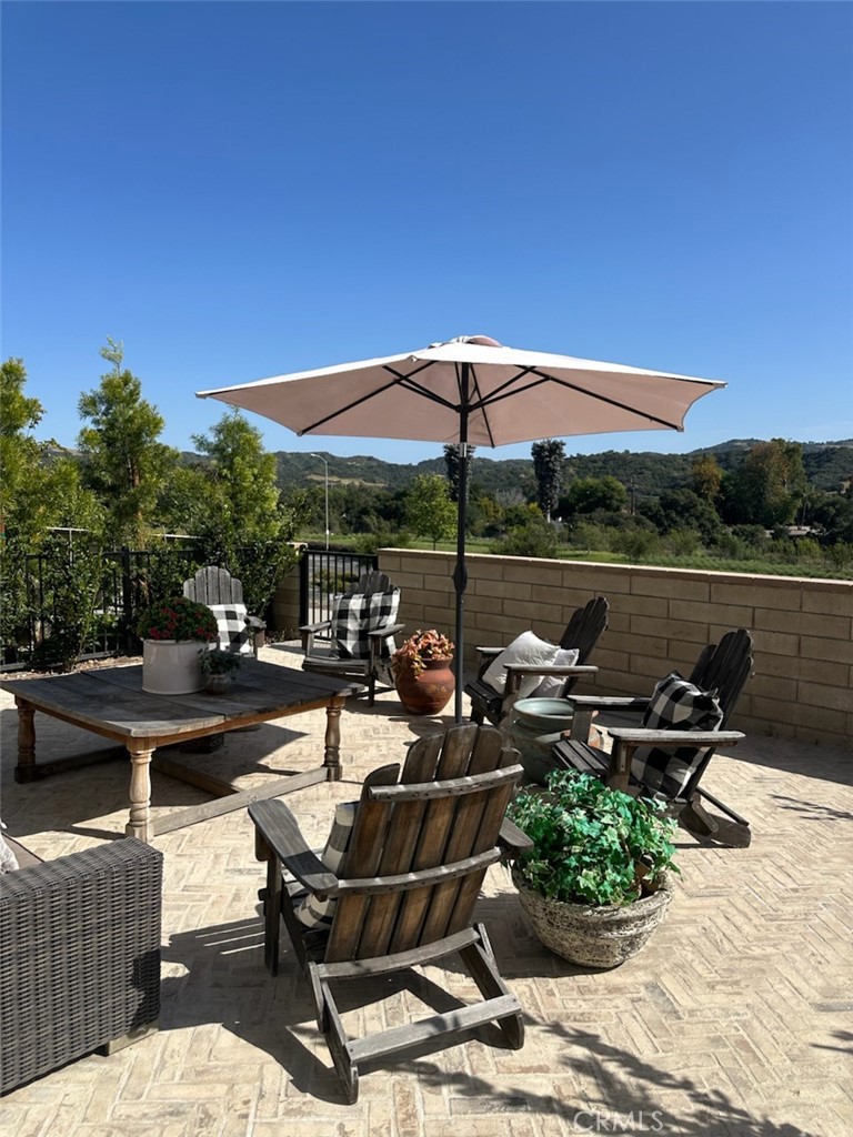 840 Barrel Way Rancho Mission Viejo, CA 92694 - Photo 4 of 57 a view of a terrace with furniture and umbrella