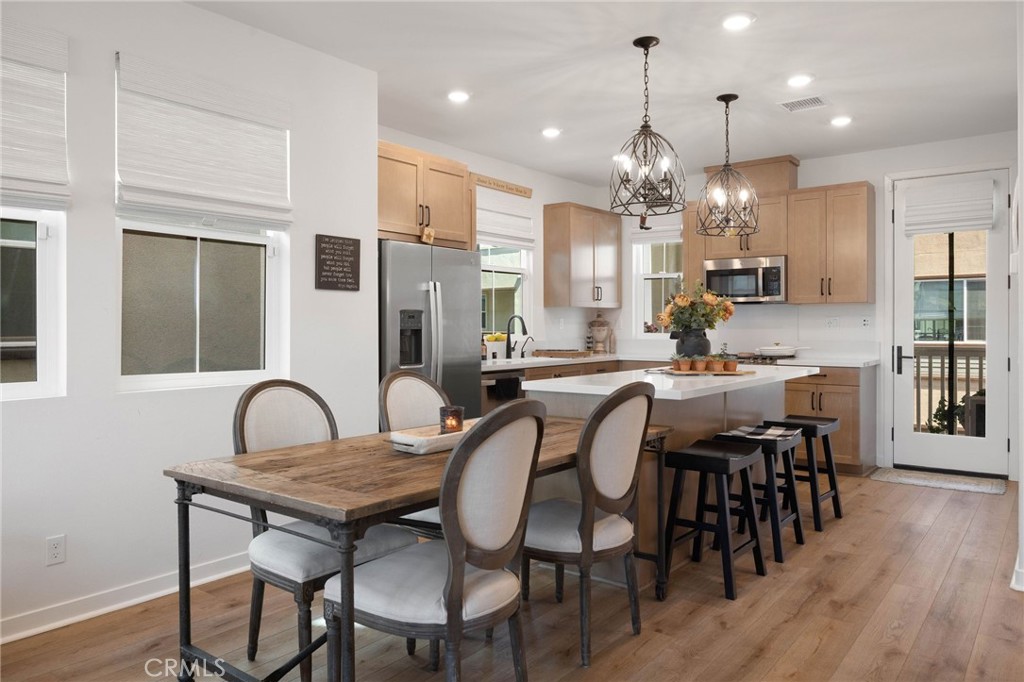 840 Barrel Way Rancho Mission Viejo, CA 92694 - Photo 6 of 57 a dining room filled chandelier and wooden floor