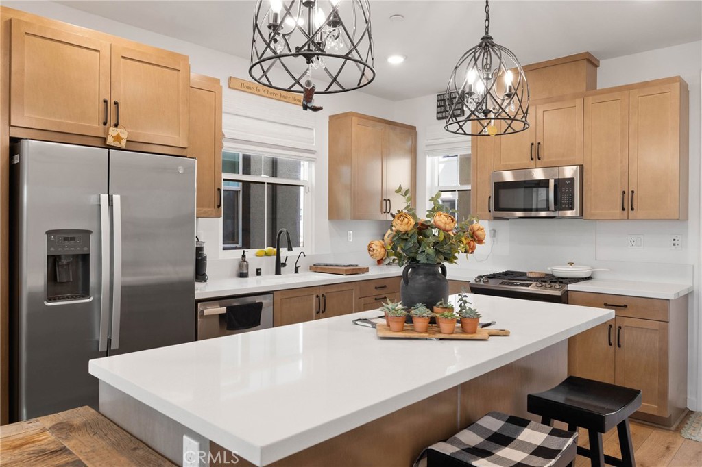 840 Barrel Way Rancho Mission Viejo, CA 92694 - Photo 7 of 57 a kitchen with stainless steel appliances a table and chairs in it
