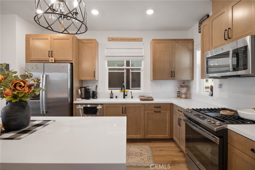 840 Barrel Way Rancho Mission Viejo, CA 92694 - Photo 8 of 57 a kitchen with stainless steel appliances a stove a sink and a refrigerator
