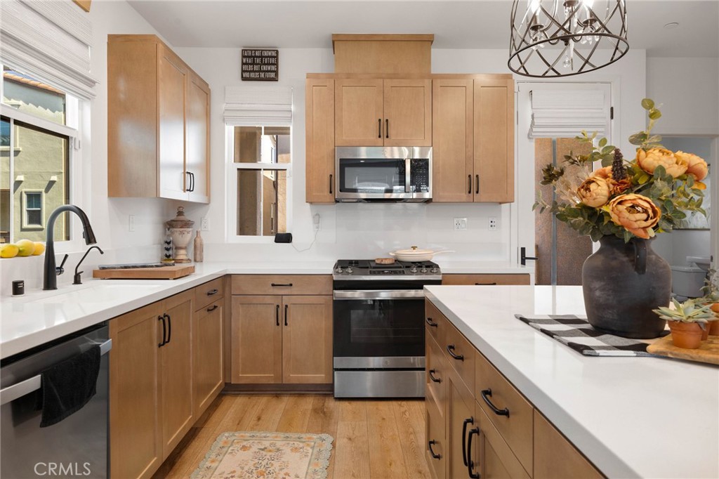 840 Barrel Way Rancho Mission Viejo, CA 92694 - Photo 9 of 57 a kitchen with stainless steel appliances granite countertop a sink stove and refrigerator
