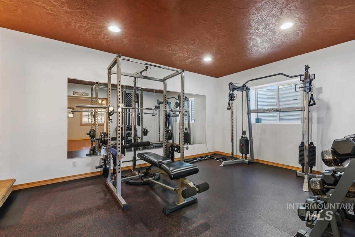 11660 Timber Butte Road Sweet, ID 83670 - Photo 35 of 49 Recessed lighting, textured ceiling finish, full-height mirror, white walls, and dark flooring