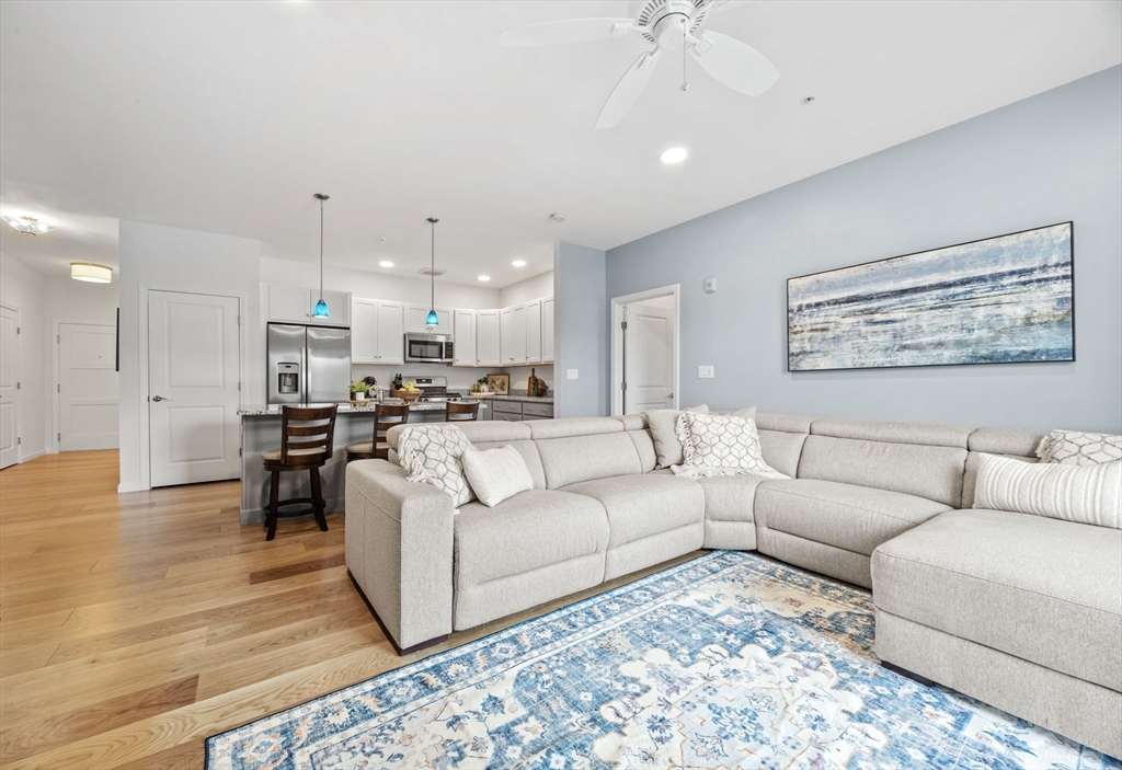 1 Mariner's Way, Unit 204 Plymouth, MA 02360 - Photo 14 of 36 a living room with furniture and kitchen view