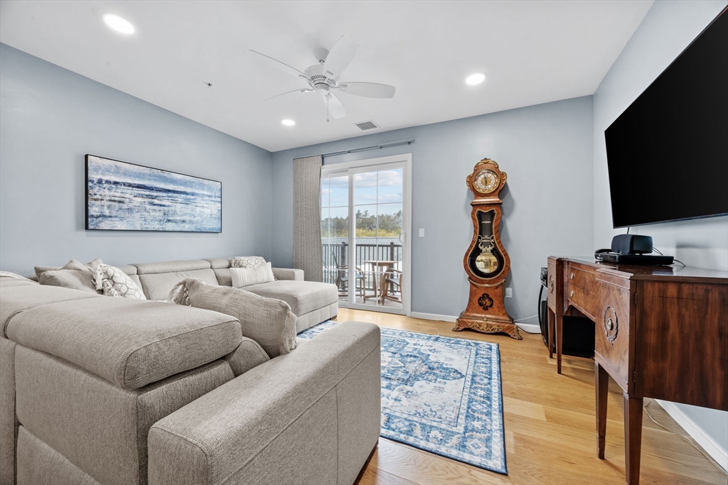 1 Mariner's Way, Unit 204 Plymouth, MA 02360 - Photo 15 of 36 a living room with furniture a flat screen tv and a window