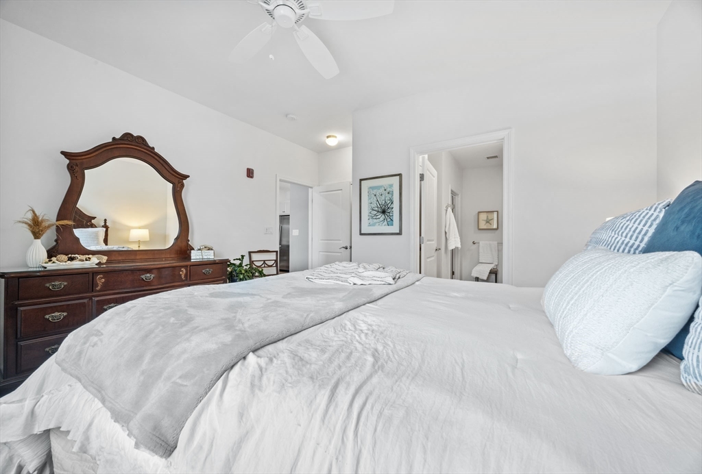 1 Mariner's Way, Unit 204 Plymouth, MA 02360 - Photo 19 of 36 a bedroom with a large bed and a dresser