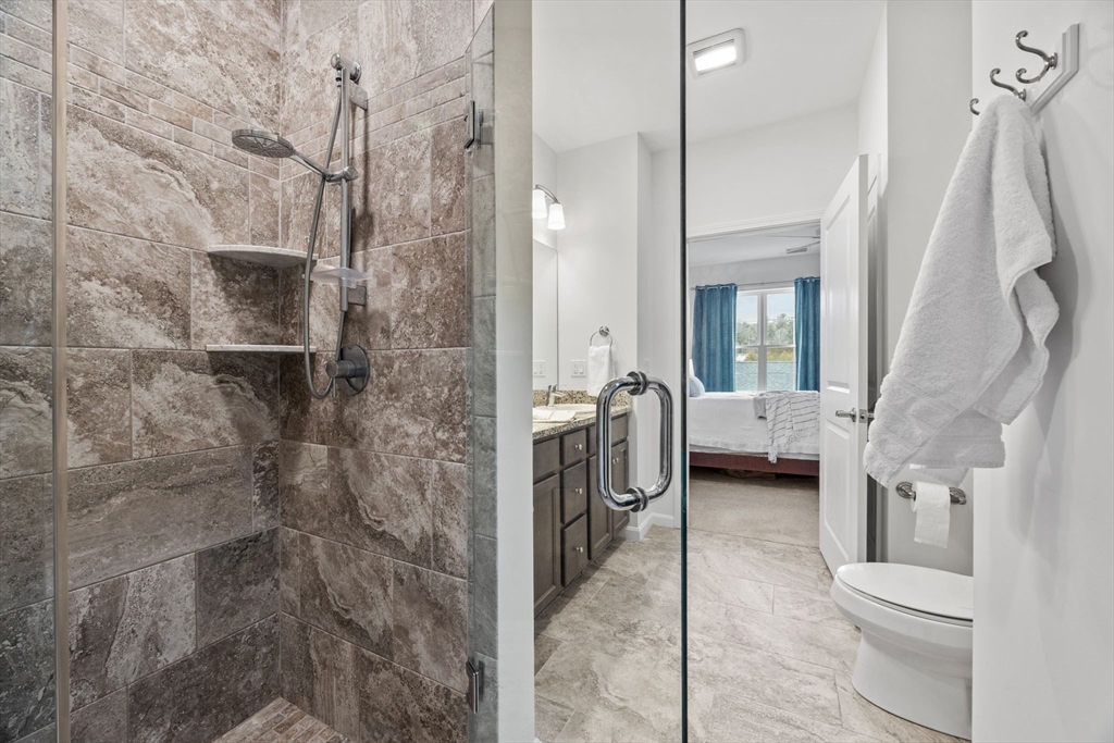 1 Mariner's Way, Unit 204 Plymouth, MA 02360 - Photo 20 of 36 a spacious bathroom with a granite countertop shower a sink and a toilet