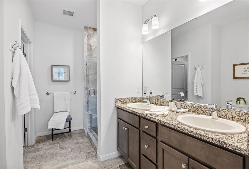 1 Mariner's Way, Unit 204 Plymouth, MA 02360 - Photo 21 of 36 a spacious bathroom with a granite countertop sink and a mirror