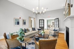 1 Mariner's Way, Unit 204 Plymouth, MA 02360 - Photo 31 of 36 a living room with fireplace furniture and a chandelier