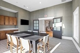 1 Mariner's Way, Unit 204 Plymouth, MA 02360 - Photo 33 of 36 a kitchen with a table chairs and wooden floor