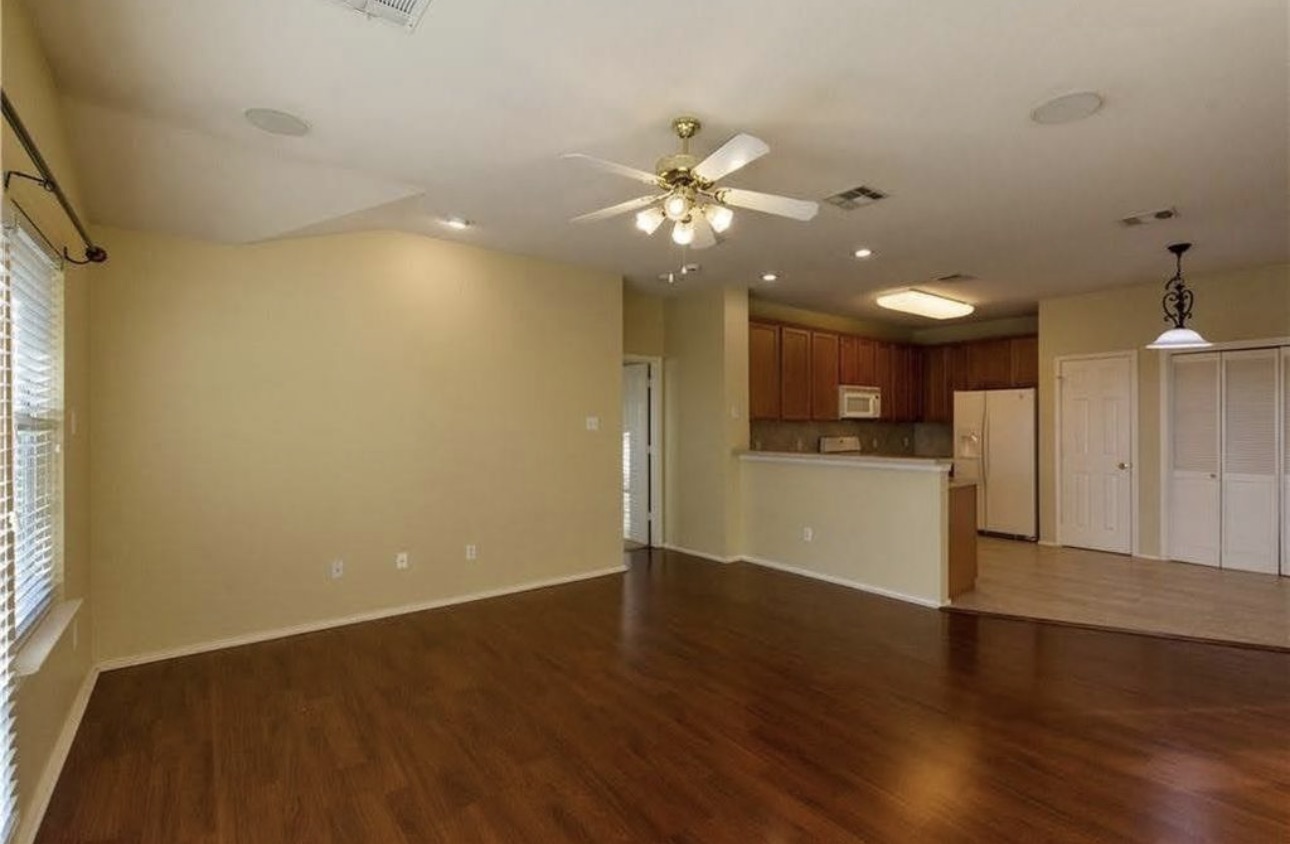 1900 Scofield Ridge Parkway, Unit 3101 Austin, TX 78727 - Photo 10 of 24 Open-concept living space featuring wood-finish flooring, a ceiling fan, recessed lighting, and a kitchen pass-through