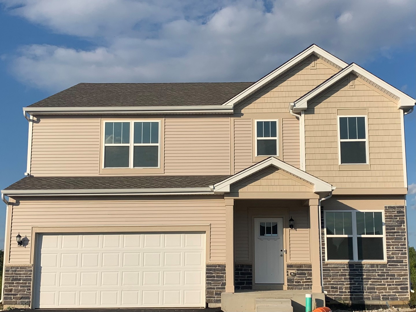 8704 Pebble Creek Court Wonder Lake, IL 60097 - Photo 1 of 24 a front view of a house with a garage