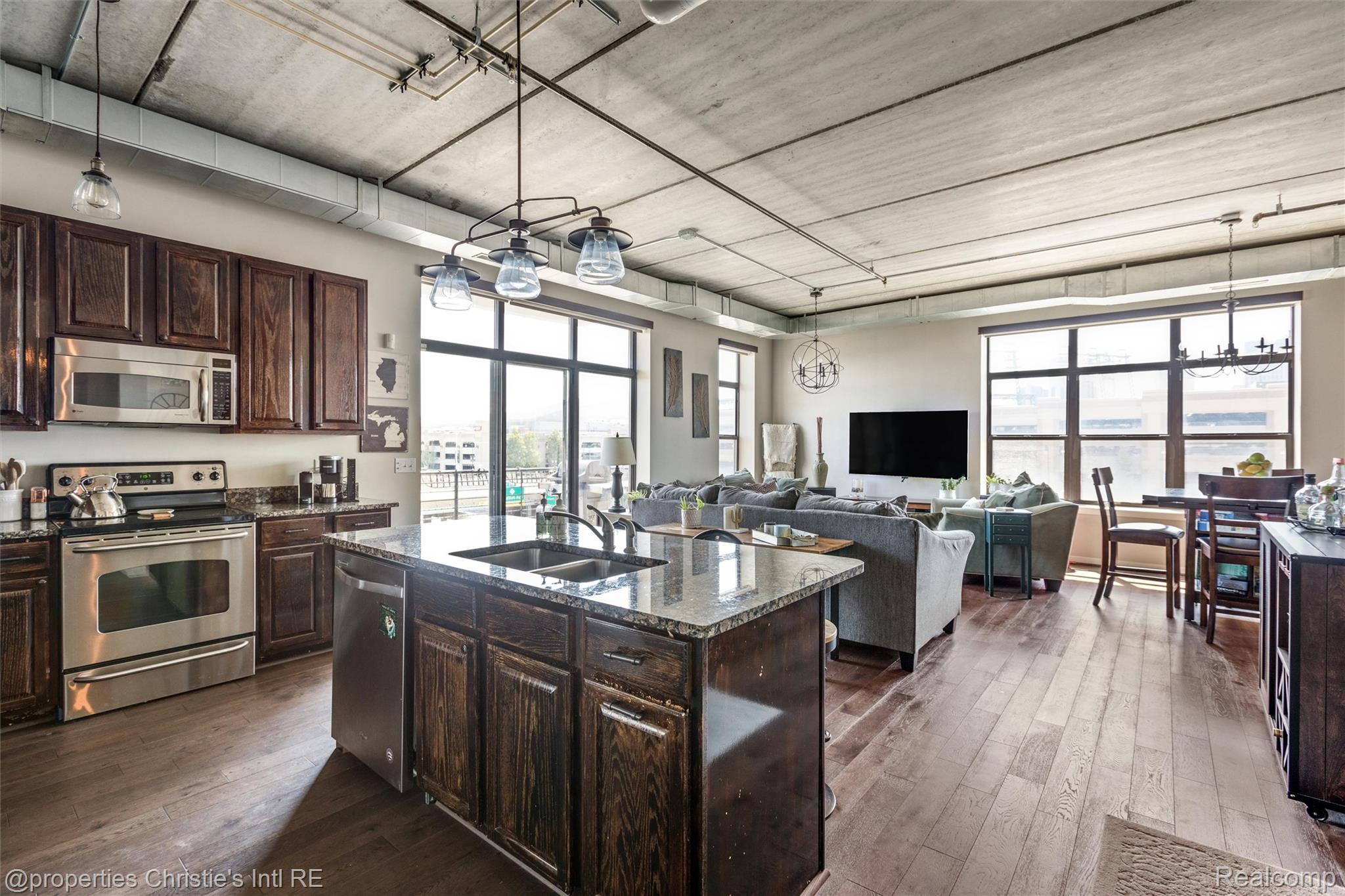 66 Winder Street, Unit 332 Detroit, MI 48201 - Photo 29 of 30 Kitchen with dark wood finish cabinets, stainless steel appliances, and open floor plan