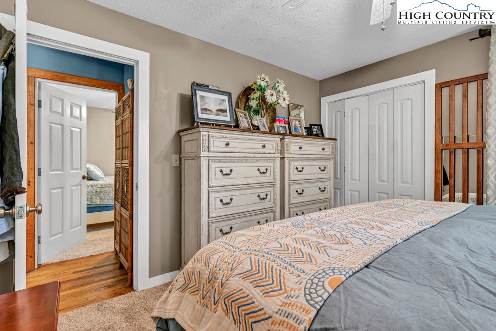 180 Wild Blackberry Hill Road Boone, NC 28607 - Photo 6 of 30 a bedroom with a bed and a dresser in it
