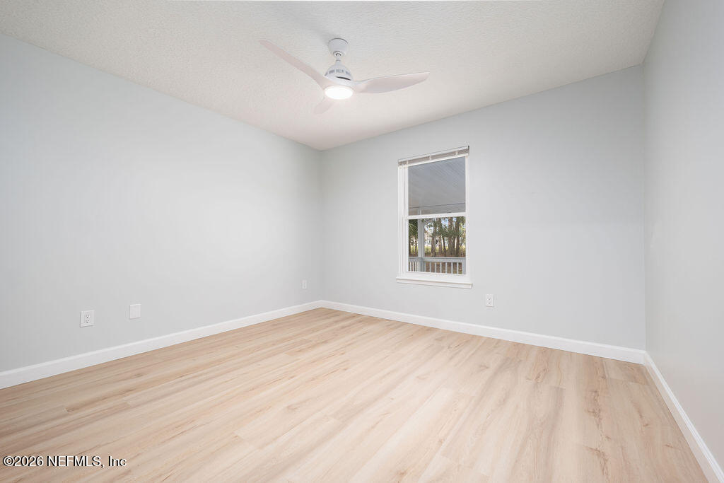 3819 Julington Creek Road Jacksonville, FL 32223 - Photo 17 of 36 an empty room with wooden floor and windows