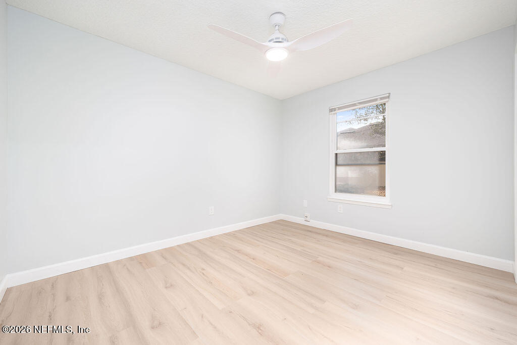 3819 Julington Creek Road Jacksonville, FL 32223 - Photo 21 of 36 an empty room with a window and ceiling fan