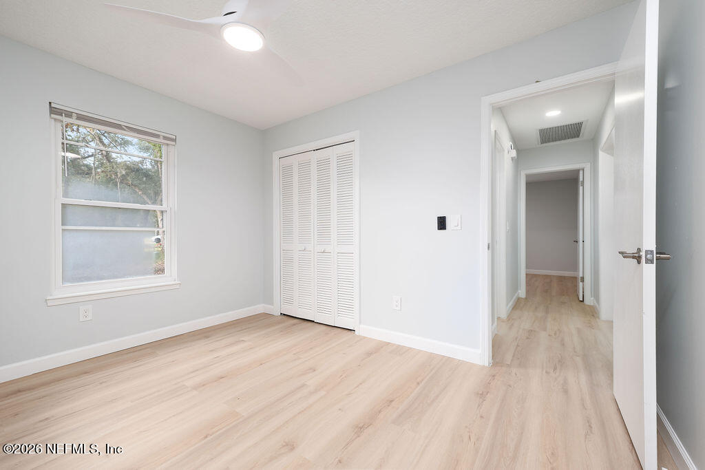 3819 Julington Creek Road Jacksonville, FL 32223 - Photo 22 of 36 a view of an empty room with wooden floor and a window