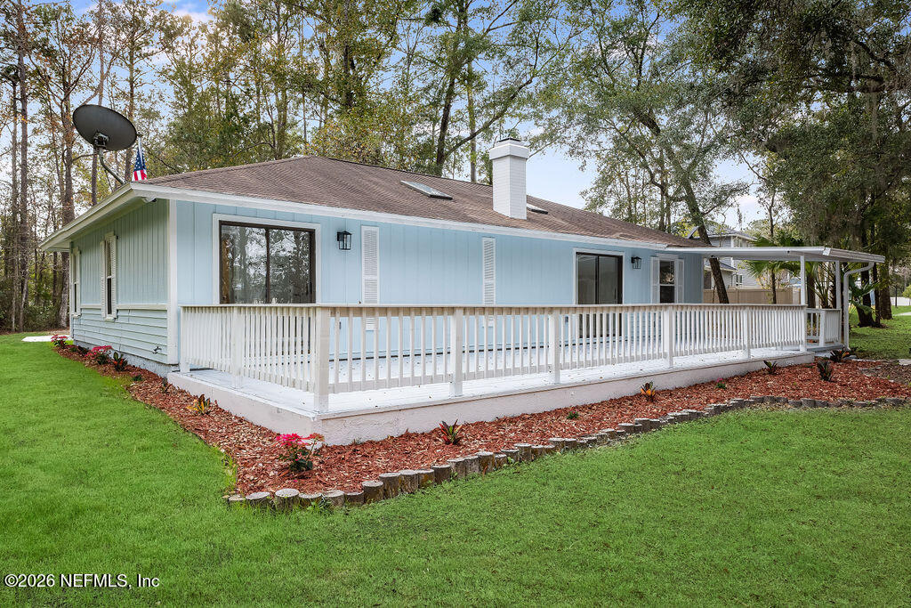 3819 Julington Creek Road Jacksonville, FL 32223 - Photo 23 of 36 a view of a house with a backyard and a deck