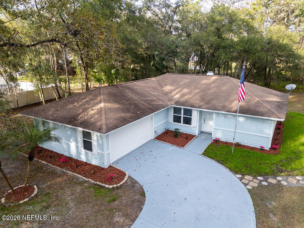 3819 Julington Creek Road Jacksonville, FL 32223 - Photo 26 of 36 an aerial view of a house with yard and trees in the background