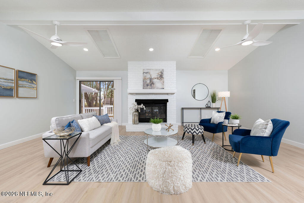 3819 Julington Creek Road Jacksonville, FL 32223 - Photo 4 of 36 a living room with furniture and a fireplace