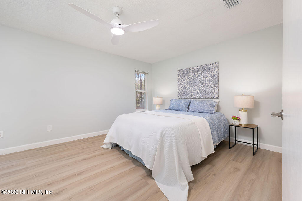 3819 Julington Creek Road Jacksonville, FL 32223 - Photo 10 of 36 a bedroom with a bed and a night lamp