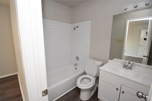 a bathroom with a sink toilet a mirror and shower