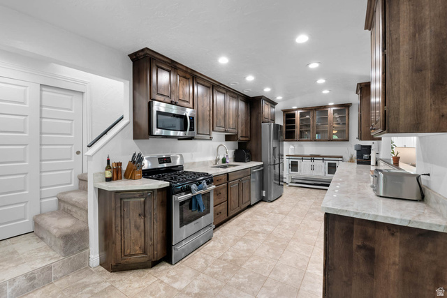 10686 South Covered Brg Cyn Road, Unit 14 Spanish Fork, UT 84660 - Photo 29 of 44 Kitchen featuring wood cabinetry, stainless steel appliances, light-colored countertops, tiled flooring, and recessed lighting