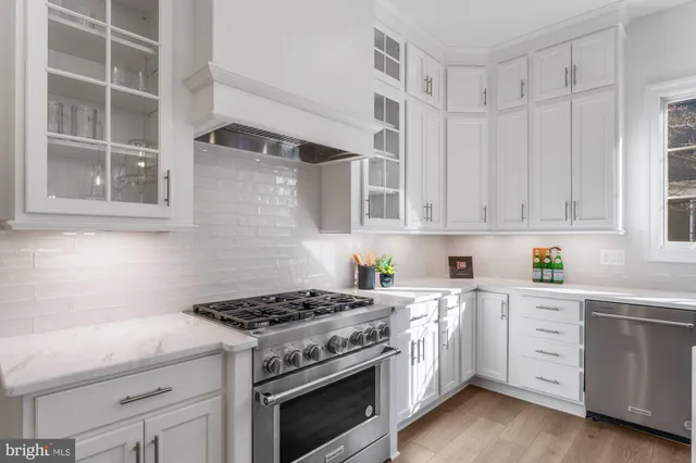 a spacious bedroom with a bed and wooden floor
