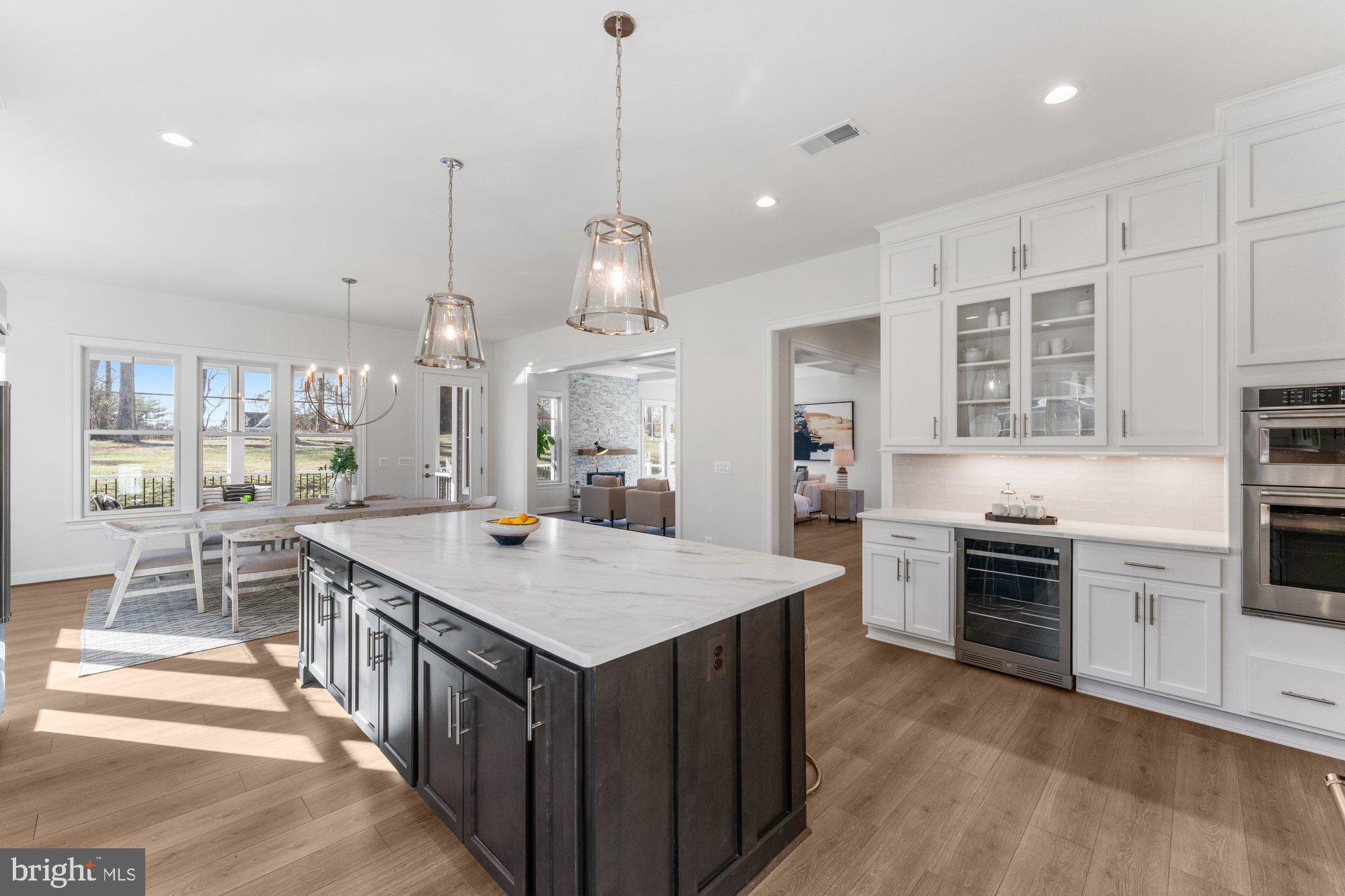 1767 Proffit Road Vienna, VA 22182 - Photo 34 of 117 a kitchen with kitchen island a stove a sink a center island and wooden floor