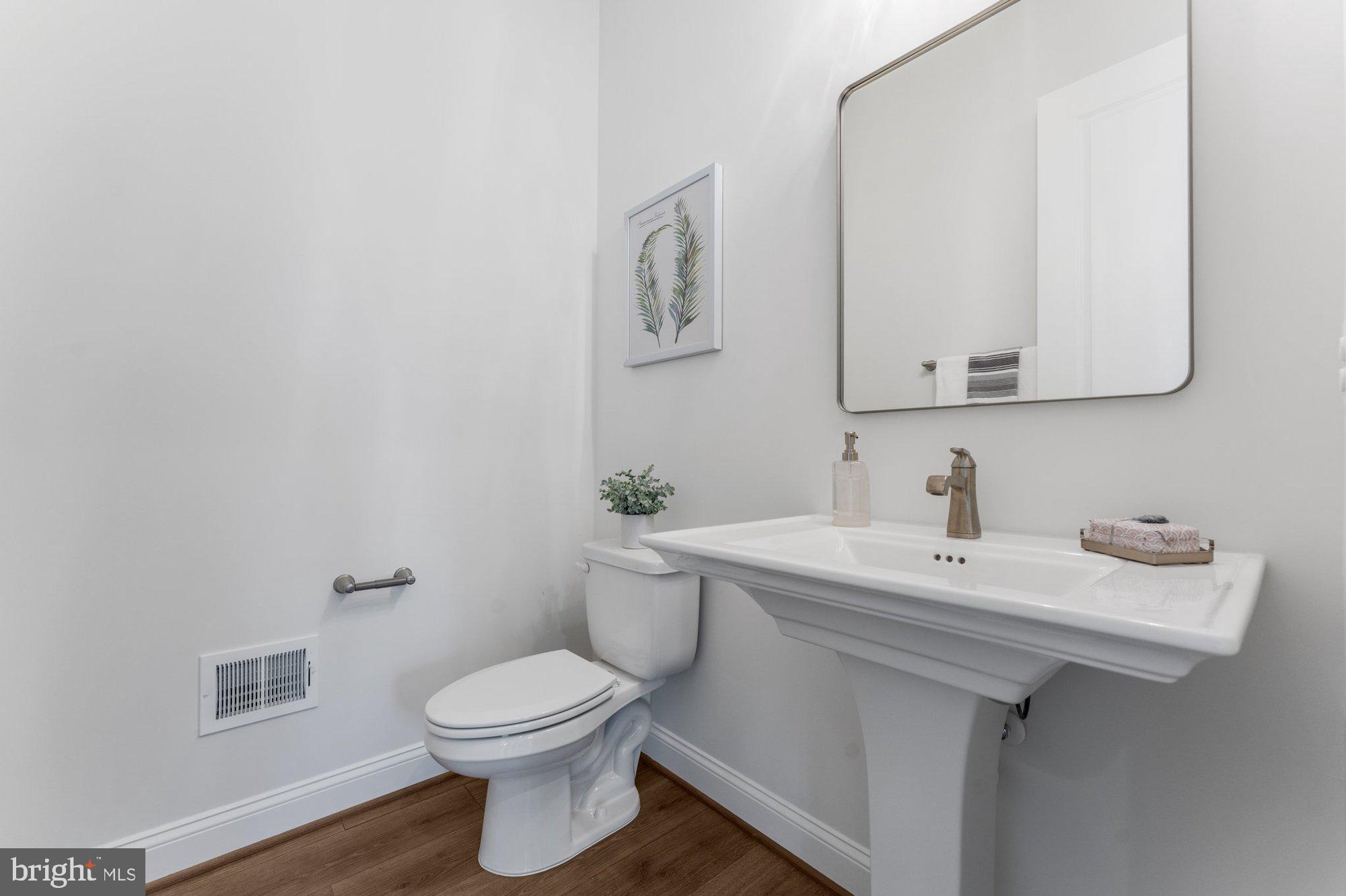 1767 Proffit Road Vienna, VA 22182 - Photo 40 of 117 a bathroom with a toilet sink and mirror