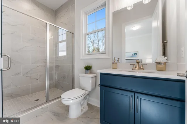 a living room with furniture and floor to ceiling windows
