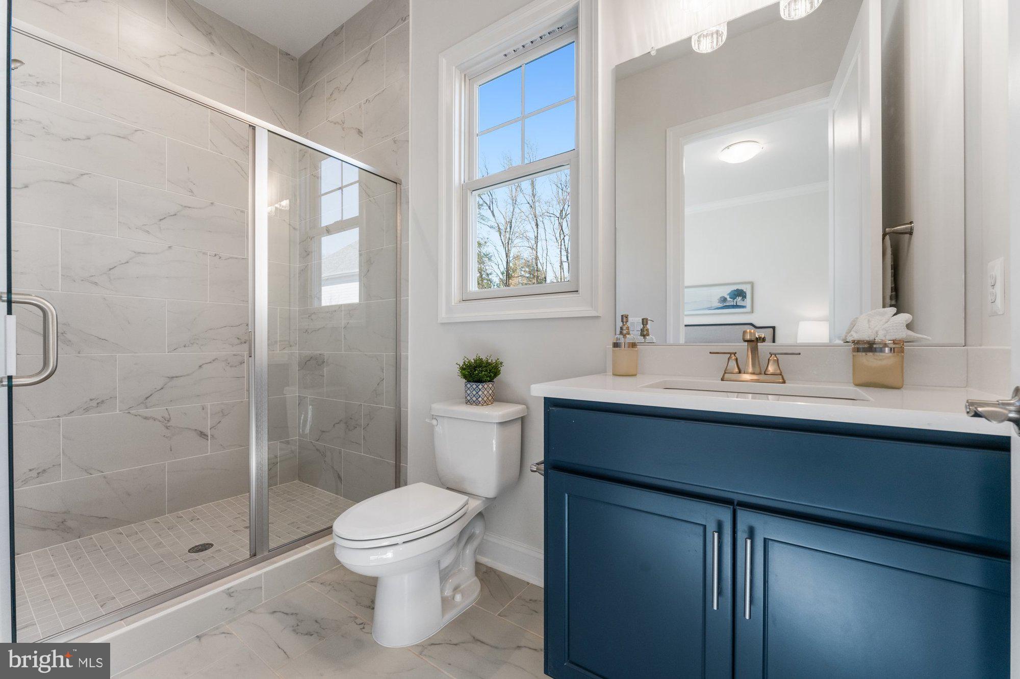1767 Proffit Road Vienna, VA 22182 - Photo 51 of 117 a bathroom with a sink toilet a mirror and shower