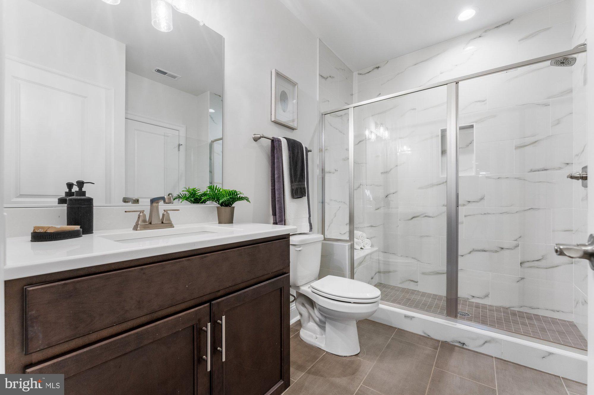 1767 Proffit Road Vienna, VA 22182 - Photo 94 of 117 a bathroom with a sink a toilet and shower