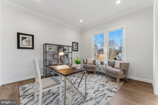 a living room with fireplace furniture and a wooden floor