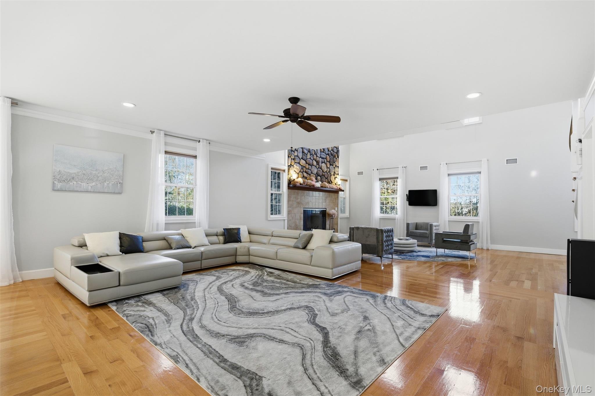 33 A Newtown Road Hampton Bays, NY 11946 - Photo 22 of 50 Living area featuring plenty of natural light, recessed lighting, ceiling fan, a fireplace, and hardwood / wood-style flooring