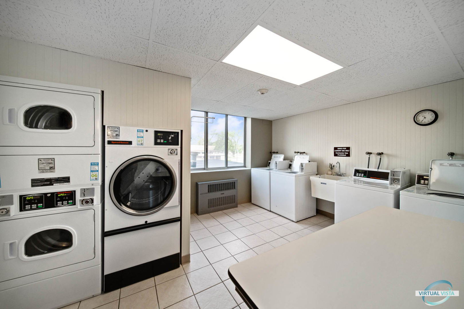 100 West Butterfield Road, Unit 210 Elmhurst, IL 60126 - Photo 25 of 27 a view of a kitchen with washer and dryer