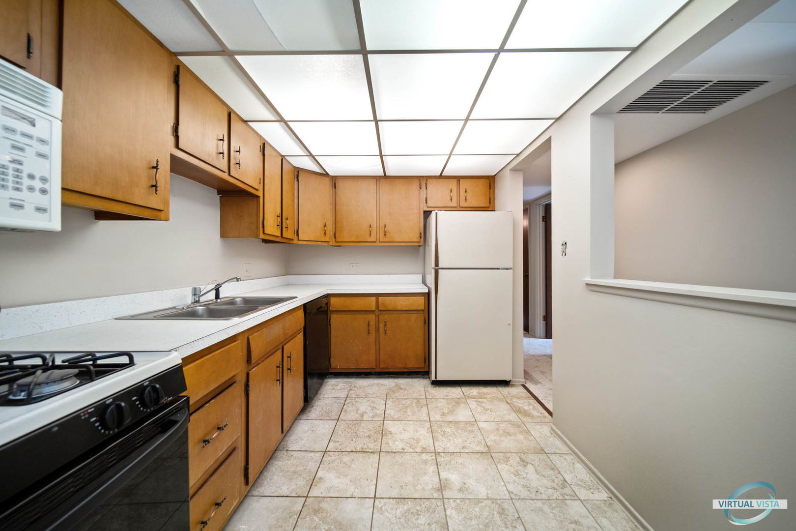 100 West Butterfield Road, Unit 210 Elmhurst, IL 60126 - Photo 7 of 27 a kitchen with a refrigerator a stove top oven cabinetry and a window