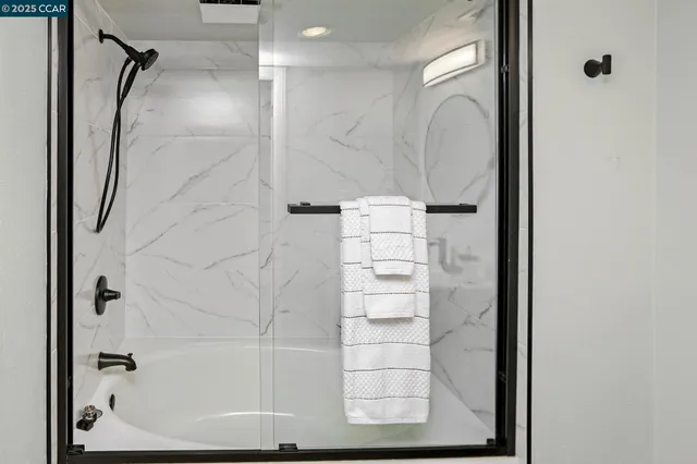 a bathroom with a shower and a sink