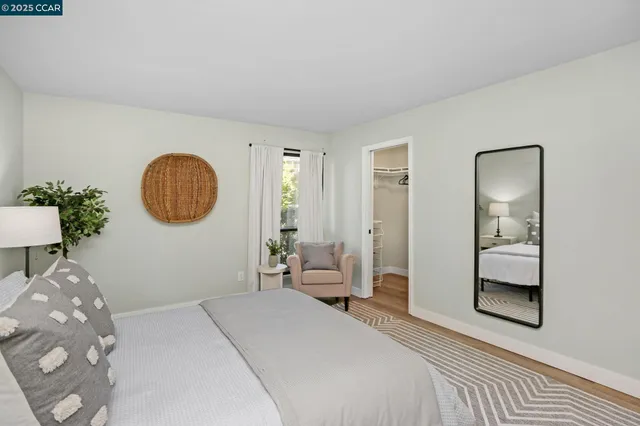 a bedroom with a bed and a mirror