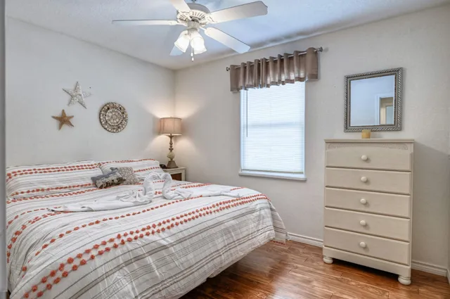 a view of a bedroom with closet and mirror