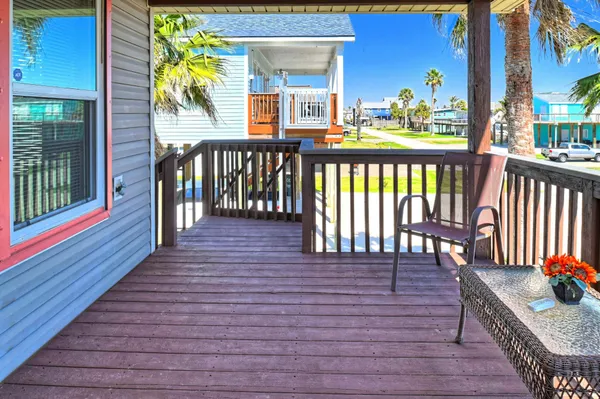 a view of balcony with wooden floor and fence