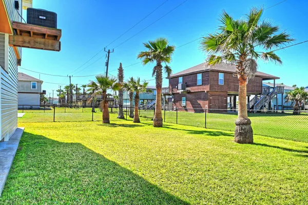 a view of a house with swimming pool and a yard