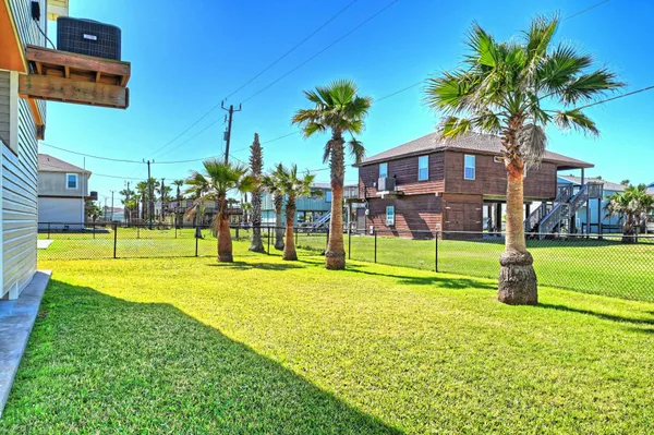 a view of a house with swimming pool and a yard