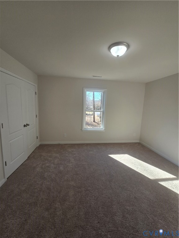 12084 Red Pine Road Ruther Glen, VA 22546 - Photo 48 of 49 Unfurnished bedroom with dark carpet and baseboard