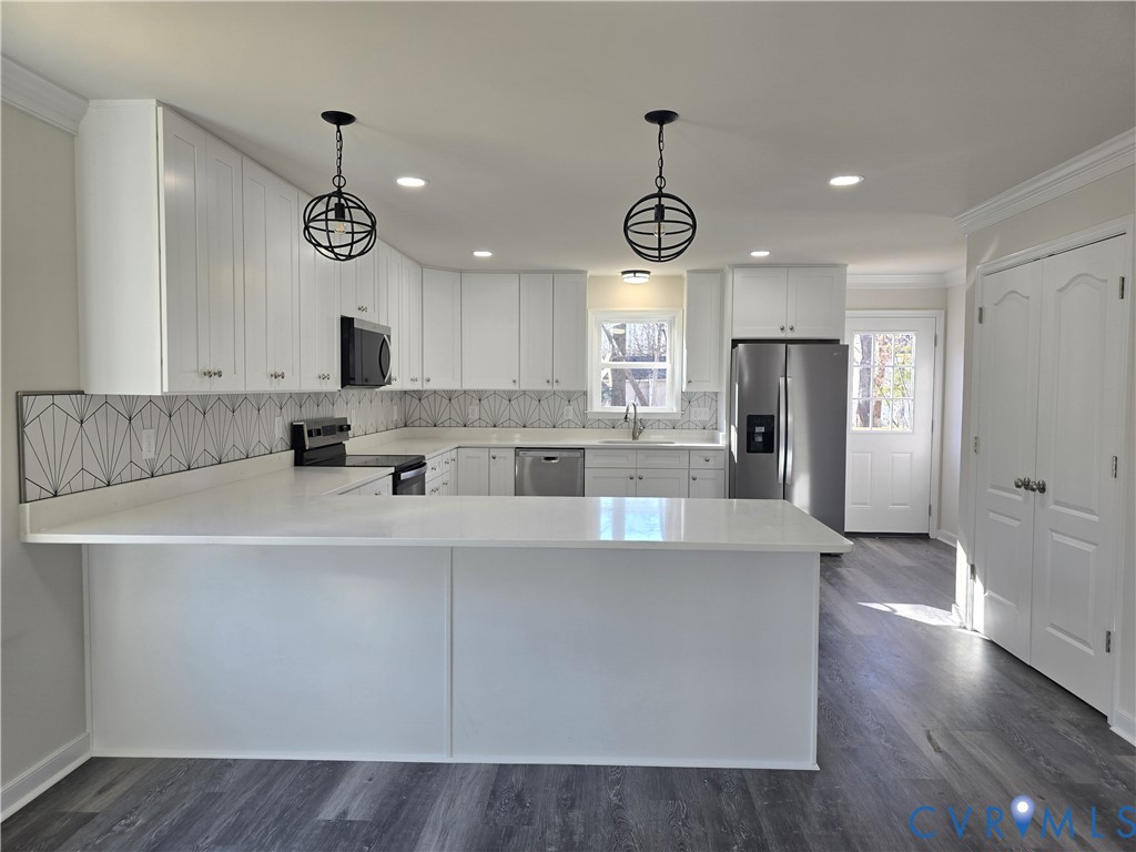 12084 Red Pine Road Ruther Glen, VA 22546 - Photo 10 of 49 Kitchen with crown molding, white cabinets, stainl