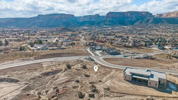 a view of a dry yard with wooden fence
