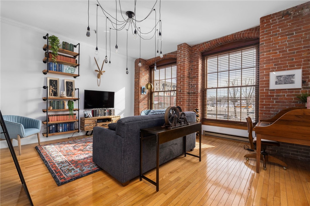 555 South Main Street, Unit 212 Providence, RI 02903 - Photo 16 of 25 The oversized living room can be utilized for multiple, additional uses. Original, exposed brick serves as a beautiful accent.