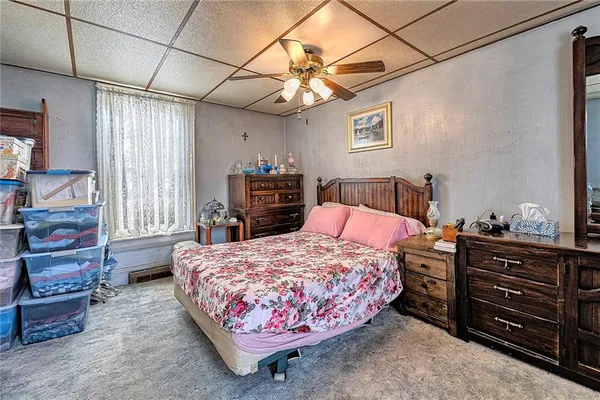 a bedroom with a bed and dresser with mirror