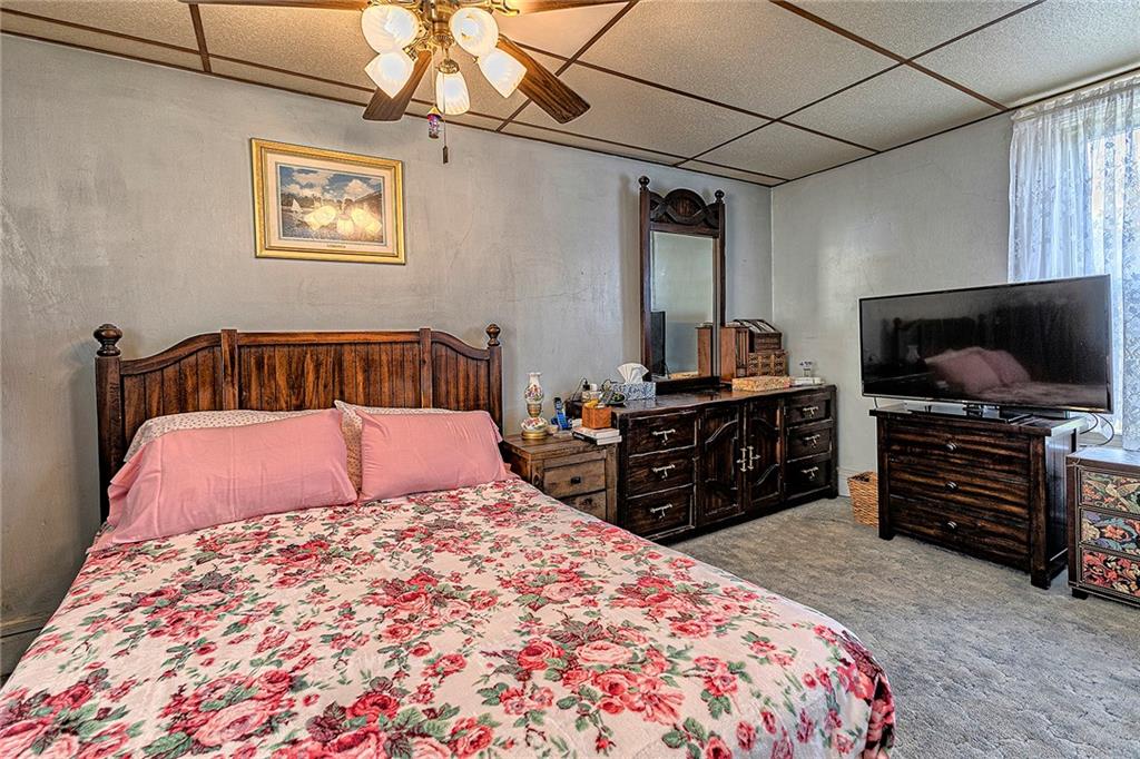 11189 Old Trail Road Irwin, PA 15642 - Photo 13 of 21 a bedroom with a bed and flat screen tv