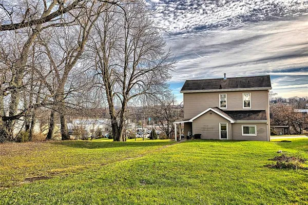 a front view of house with yard and green space
