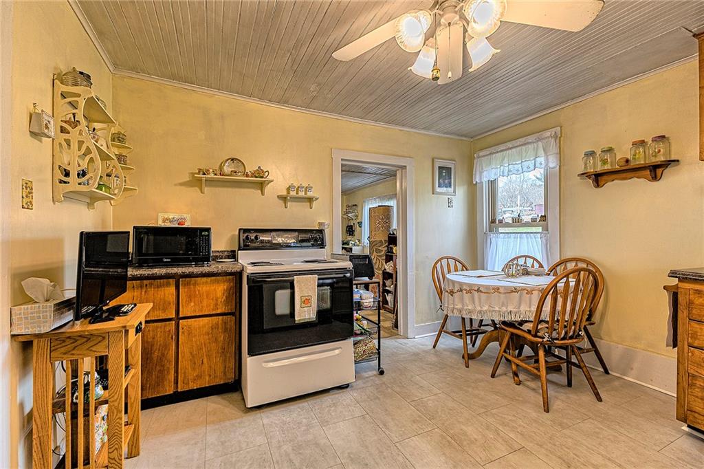 11189 Old Trail Road Irwin, PA 15642 - Photo 3 of 21 a kitchen with stainless steel appliances kitchen island granite countertop furniture and a dining table